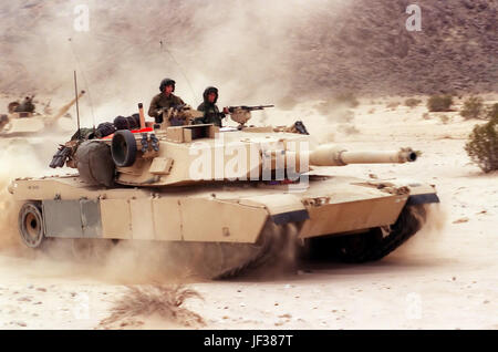 000201-M-5802T-006 Marines of the 2nd Marine Division's 2nd Tank Battalion maneuver their M-1A1 main battle tanks during a Combined Arms Exercise at the Marine Corps Air Ground Combat Center, Twentynine Palms, Calif., on Feb. 1, 2000.  The exercise is designed to involve all elements of the Marine Air Ground Task Force in a live fire, desert training environment.  DoD photo by Pfc. Andrew A. Thornton, U.S. Marine Corps.  (Released) Stock Photo