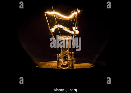 Old light bulb close-up on a dark background. Stock Photo