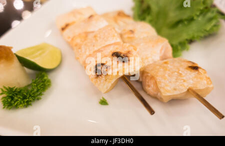 Grilled bottom part of Salmon with salt on white plate Stock Photo
