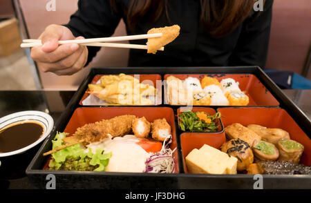 women eating  bento box set in japanese restaurant
