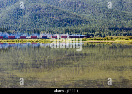 Canadian Pacific Railroad Train  passing by the Vermillion Lakes near the town of Banff, in Banff National Park, Alberta, Canada. Stock Photo