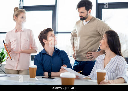 group of young business people discussing new project on small business meeting Stock Photo