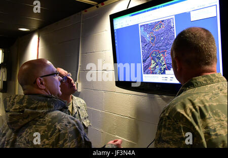 Tech. Sgt. Daron, a member of the 236th Intelligence Support, shows two airmen a map of the fires in east Tennessee on Jan. 7, 2017 a Berry Field Air National Guard base in Nashville, TN. The 236th IS provided valuable imagery and mapping support to the Tennessee Emergency Management Agency and other civilian agencies fighting the fires. (U.S. Air National Guard photo by Senior Airman Anthony Agosti) Stock Photo