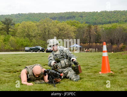 Sgt. Michael Cohen, a member of the D.C. National Guard won the best noncommissioned officer portion of the Region II Best Warrior Competition held at Fort Indiantown Gap May 11-14. One of the Warrior Tasks each Soldier was challenged with completing was to resupply ammunition to an M249 light machine gun emplacement. (U.S. Army National Guard photo by Sgt. Zane Craig) Stock Photo