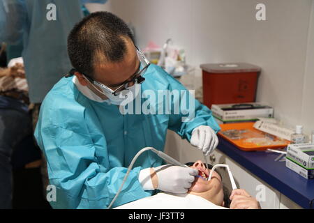 Appalachia IRT Dental Officer in Charge from the 455th Dental Company in Devens Reserve Forces Training Area, Mass., Maj. Takashi Komabayashi, provides dental care during Appalachia IRT 2017 which took place from May 14-27 at the Wise County Fairgrounds in Wise, Va. Stock Photo