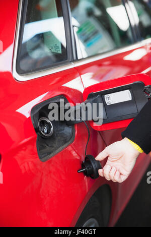Woman pumping gas Stock Photo - Alamy