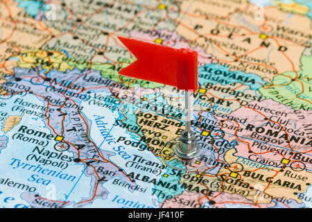 Photo of Montenegro marked by red flag in holder. Country on European continent. Stock Photo