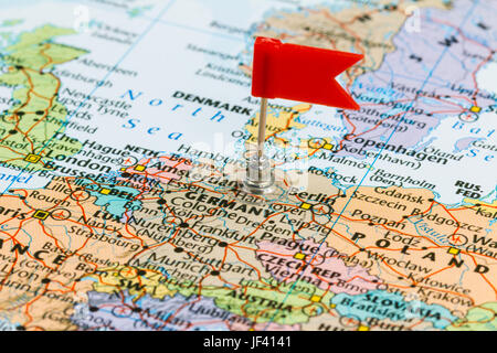 Photo of Germany marked by red flag in holder. Country on European continent. Stock Photo