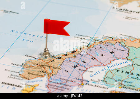 Photo of Norway marked by red flag in holder. Country on European continent. Stock Photo