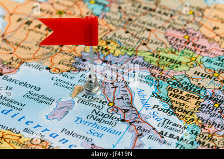 Photo of Italy marked by red flag in holder. Country on European continent. Stock Photo