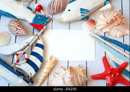 Blank white greeting card with white Starfish and seashells on blue small stone pebbles Stock Photo