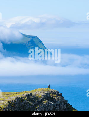 Seaside cliffs, person on background Stock Photo