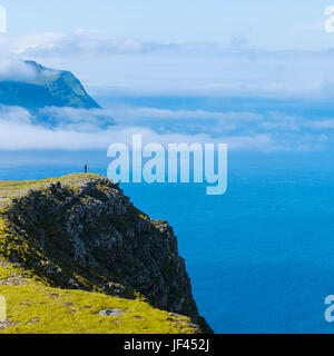 Seaside cliffs, person on background Stock Photo