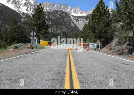 Road closed gate on the Tioga Pass in June 2017. After a record amount of snow during the winter of 2016/17 the road would open on june 29 2017 Stock Photo