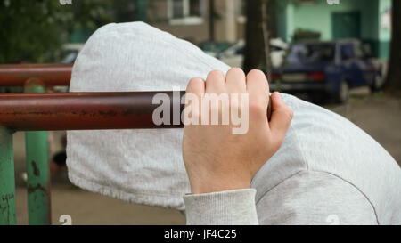 A strong, healthy man, doing pullups on the bars Park Sunrise workout, Stock Photo