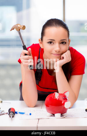 Young woman in coveralls doing repairs Stock Photo