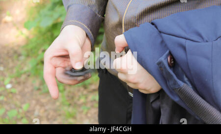 young businessman turns black spinner in the forest. Stock Photo