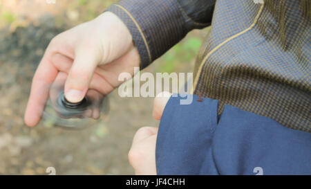 young businessman turns black spinner in the forest. Stock Photo