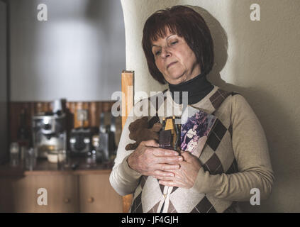 Senior woman hold pictures Stock Photo