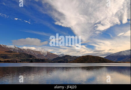 A landscape view of Mount Aspring and norwest cloud formations  in the background. In the foreground is Lake Wanaka. Central Otago, New Zealand. Plent Stock Photo
