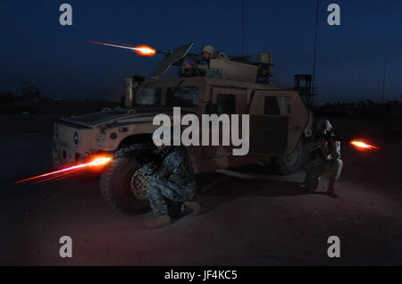050730-N-6501M-100  U.S. Army Spc. Ronnie Scibek (top), Sgt. Glenn Santos (left) and Spc. Kyle Hurt participate in a nighttime live fire training exercise at the Iraqi Army Compound firing range on Forward Operating Base Iskandariyah, Iraq, on July 30, 2005.  The soldiers are attached to Bravo Company, 490th Civil Affairs Battalion, 155th Brigade Combat Team. DoD photo by Chief Petty Officer Edward G. Martens, U.S. Navy.  (Released) Stock Photo