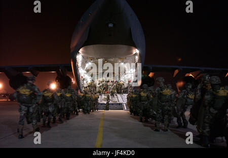 060124-F-0929W-177  Paratroopers from the U.S. Army's 82nd Airborne Division line up to board a U.S. Air Force C-17 Globemaster III aircraft for a night parachute jump during joint forcible entry exercise at Pope Air Force Base, N.C., on Jan. 24, 2006.  The 82nd is from nearby Fort Bragg, N.C.  DoD photo by Tech. Sgt Sean M. Worrell, U.S. Air Force.  (Released) Stock Photo