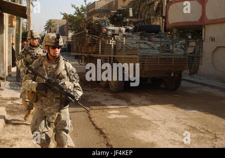 061211-A-0350A-084         U.S. Army soldiers from 5th Battalion, 20th Infantry Regiment provide security for Iraqi army soldiers during a patrol in Adhamiya, Iraq, on Dec. 11, 2006.  The intent of the patrol is to decrease sectarian violence and insurgent activity while increasing the Iraqi security force's capabilities.  DoD photo by Spc. Jeffrey Alexander, U.S. Army.  (Released) Stock Photo