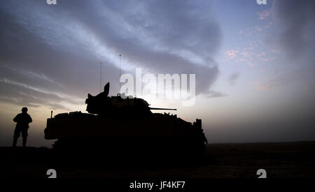 041117-F-2034C-033 U.S. Army Spc. Jake Garrison keeps a look out by his M3A3 Bradley Cavalry Fighting Vehicle during a combat security patrol outside Ancient Samarra, near Ad Dwr, Iraq, on Nov. 17, 2004.  Garrison is assigned to 1st Battalion, 4th Cavalry Regiment, 1st Infantry Division.  DoD photo by Staff Sgt. Shane A. Cuomo, U.S. Air Force.  (Released) Stock Photo