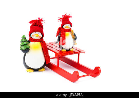 Two penguins with sleigh and christmas tree Stock Photo