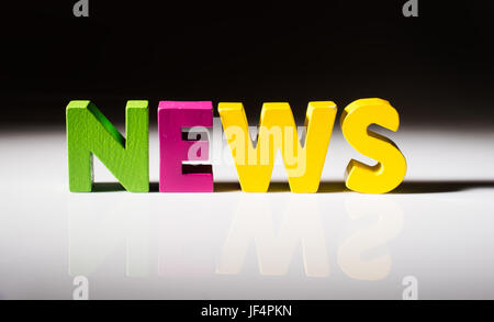 Multicolored word news made of wood. Stock Photo