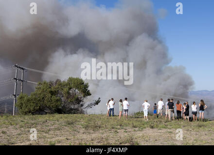 San Clemente, California, USA. 28th June, 2017. A crowd gathers to watch fire and smoke work its way north just south east of San Clemente along Via Promontory on Wednesday afternoon. A vegetation fire broke out along Cristiantos Road just south east of San Clemente, California on Wednesday afternoon prompting response from the Orange County Fire Authority in addition to Cal Fire, Camp Pendleton Fire and other agencies across San Diego County. Credit: David Bro/ZUMA Wire/Alamy Live News Stock Photo