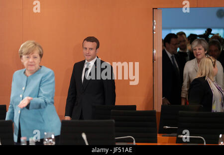 German Chancellor Angela Merkel, left, France's President Emmanuel Macron and British Prime Minister Theresa May, right, enter the room prior to a gathering of European leaders on the upcoming G-20 summit in the chancellery in Berlin, Germany, Thursday, June 29, 2017. Photo: Markus Schreiber/AP Pool/dpa Stock Photo