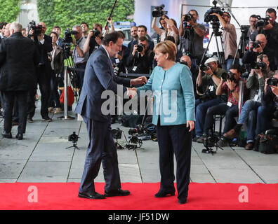 Berlin, Germany. 29th June, 2017. German Chancellor Angela Merkel (R) greets Spanish Prime Minister Mariano Rajoy (L) before the preparation meeting for G20 at German Chancellery in Berlin, capital of Germany, on June 29, 2017. Credit: Shan Yuqi/Xinhua/Alamy Live News Stock Photo