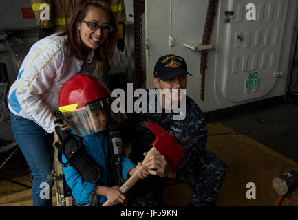 170527-N-QI061-085    NEW YORK (May 29, 2017) Damage Controlman 2nd Class Shawn Van Natta, poses for a picture during a guided tour aboard the guided-missile cruiser USS Monterey (CG 61) for Fleet Week New York. Fleet Week New York, now in its 29th year, is the city’s time honored celebration of the sea services. It is an unparalleled opportunity for the citizens of New York and the surrounding tri-state area to meet Sailors, Marines and Coast Guardsmen, as well as witness firsthand the latest capabilities of today’s maritime services. (U.S. Navy photo by Mass Communication Specialist 3rd Clas Stock Photo