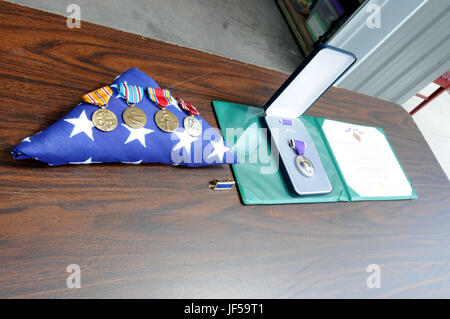 The medals and awards to be presented to the family of Pfc. Herbert A. Grue, who was killed in 1942 while serving in the Pacific theater of operations, are displayed on a table prior to a presentation for the surviving family members at the Birchwood, Wisconsin-home of Grue's granddaughter Laura Ekstrom, May 28. Stock Photo