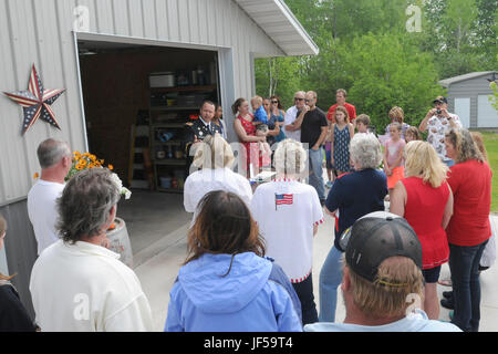 Maj. Chris Spencer, retirement services officer with the 88th Regional Support Command, discusses the medals and awards earned by World War II Pfc. Herbert A. Grue during a ceremony honoring his service, May 28. The awards and medals were presented to the surviving family members. Grue was killed in action November 16, 1942. Stock Photo