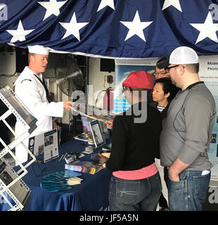 170528-N-N0701-001 NEW YORK (May 28, 2017) Mass Communication Specialist 1st Class J.R. Peregrino, assigned to U.S. Fleet Forces Command, discusses plastic waste processing with visitors at the “Stewards of the Sea: Defending Freedom, Protecting the Environment” exhibit aboard the guided-missile cruiser USS Monterey (CG 61) at the Brooklyn Cruise Terminals during Fleet Week New York. The Navy employs every means available to mitigate the potential environmental effects of our activities without jeopardizing the safety of our Sailors or impacting our Navy readiness mission. (U.S. Navy photo by  Stock Photo