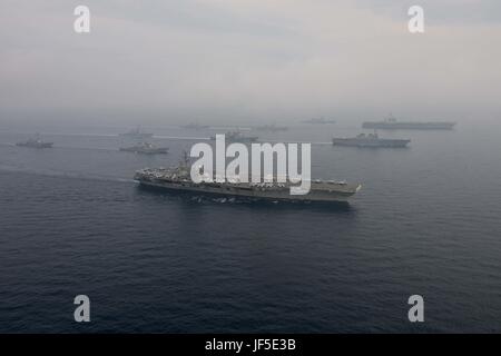 170601-N-OY799-1389 SEA OF JAPAN (June 1, 2017) The Carl Vinson strike group, including USS Carl Vinson (CVN 70), Carrier Air Wing (CVW) 2, guided-missile cruiser USS Lake Champlain (CG 57) and guided-missile destroyers USS Wayne E. Meyer (DDG 108) and USS Michael Murphy (DDG 112), operates with the Ronald Reagan strike group including, USS Ronald Reagan (CVN 76), Carrier Air Wing (CVW) 5, guided-missile cruiser USS Shiloh (CG 67), guided-missile destroyers USS Barry (DDG 52), USS McCambell (DDG 85), USS Fitzgerald (DDG 62), and USS Mustin (DDG 89) and the Japanese Ships (JS) Hyuga (DDH 181) a Stock Photo