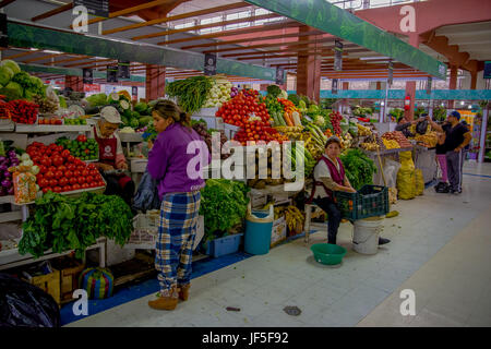 QUITO, ECUADOR - NOVEMBER 23, 2016: Unidentified people buying food, vegetables and fruits at the municipal market located in Saint Francis. Stock Photo