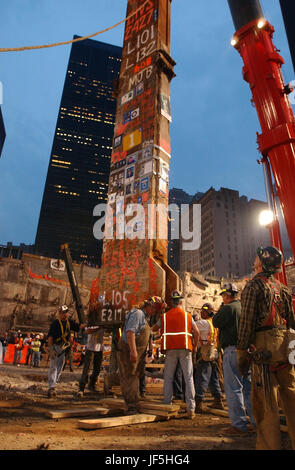 020528-N-3783H-355 New York City (May 28, 2002) -- Construction workers carefully maneuver the last piece of debris removed from ÒGround ZeroÓ.  The event marked the final removal of the last remaining World Trade Center structure, Column Number 1001B of Two World Trade Center.  The 30-foot column remained standing following the collapse of the twin towers, when terrorists flew two commercial airliners into both skyscrapers on September 11, 2001.  The resulting collapse created a mountain of 1.8 million tons of steel and concrete. More than 3000 people perished in the attack. Stock Photo