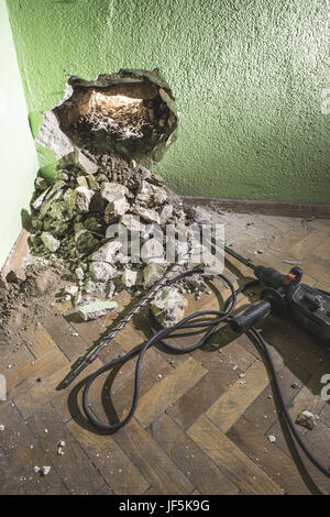 Drilling a big hole in the wall Stock Photo