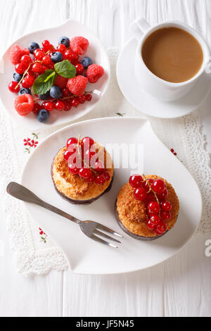 Coconut muffins with currants and coffee with milk close-up on the table. vertical view from above Stock Photo