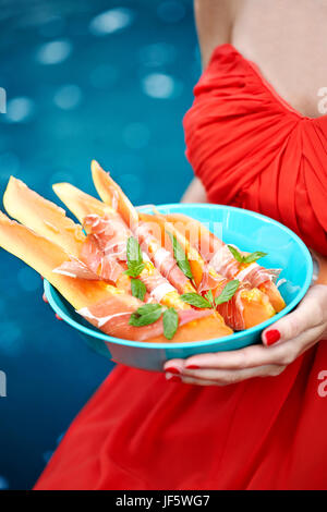 Woman holding food in bowl Stock Photo