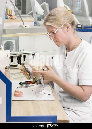 Dental technician making dentures Stock Photo