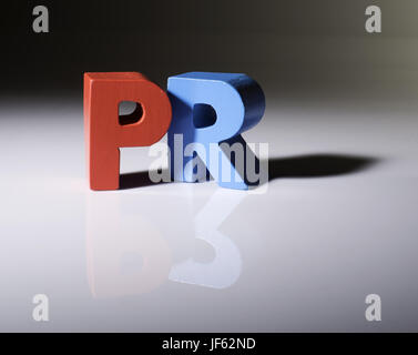 Multicolored word PR made of wood. Stock Photo