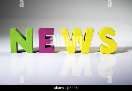 Multicolored word news made of wood. Stock Photo