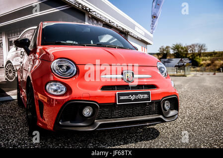 Red Fiat Abarth 595 front view with logo on nose in car Stock Photo