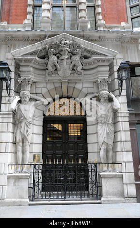 Door entrance of Draper's Hall with classical stone statues leading on to Throgmorton Street in The City of London UK  KATHY DEWITT Stock Photo