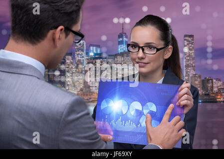 Business people discussing stock chart trends Stock Photo