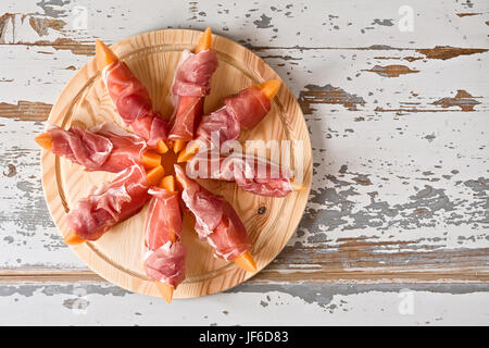 Italian food with prosciutto and melon Stock Photo